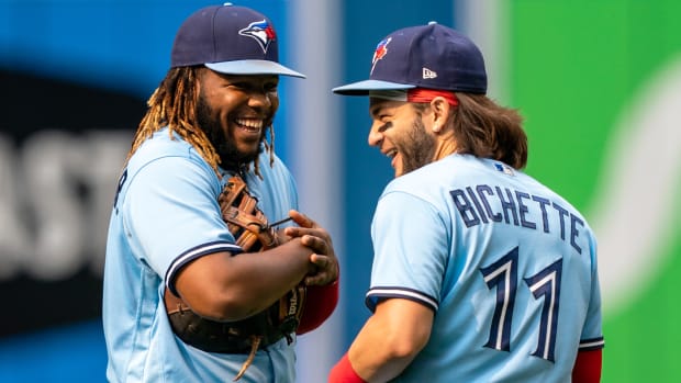Jul 31, 2021; Toronto, Ontario, CAN; Toronto Blue Jays designated hitter Vladimir Guerrero Jr. (27) and shortstop Bo Bichette (11) have a laugh at Rogers Centre.